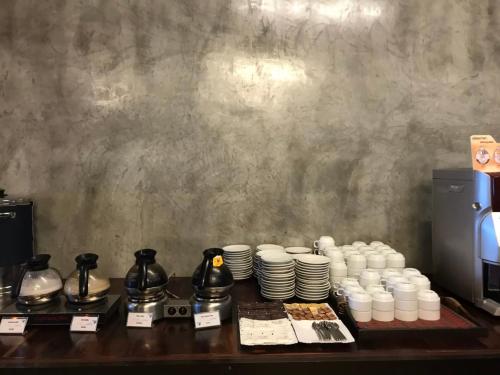 a table with cups and plates on a counter at Bundhaya Villas in Ko Lipe