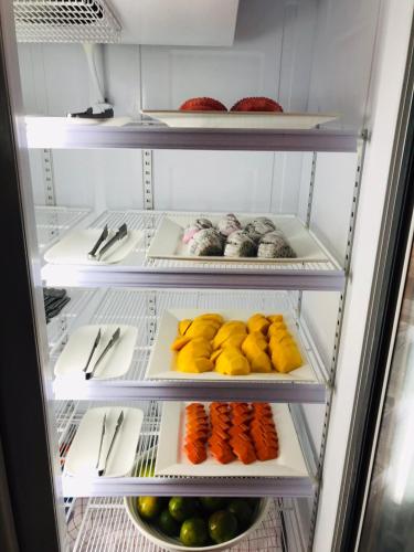 a refrigerator filled with lots of fruits and vegetables at Bundhaya Villas in Ko Lipe