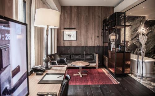 a living room with a couch and a table at Hotel Proverbs Taipei in Taipei