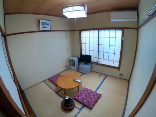 a living room filled with furniture and a window at Yuzawa Ski House in Yuzawa
