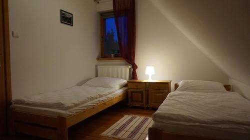 Posteľ alebo postele v izbe v ubytovaní Pod Kasztanami
