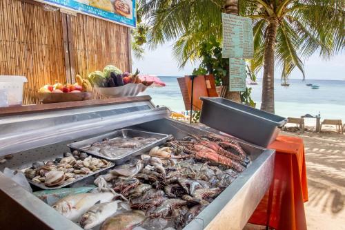 a grill with shrimp and other seafood on the beach at Hayahay Resort in Panglao