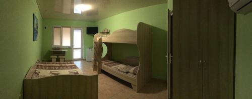 a small green room with a bunk bed in it at Mini-hotel Zefir in Zatoka