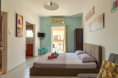 a bedroom with a bed with two pillows on it at 3rd Floor Apartment next to the BeachFront in Heraklio Town
