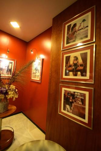 a room with pictures on the wall of a bathroom at Brazilia Suites Hotel in Baabda