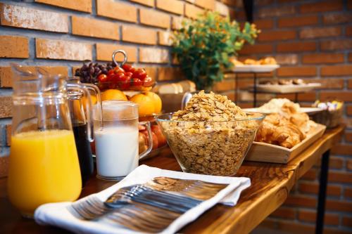a table topped with breakfast foods and orange juice at Hotel MIDO Myeongdong in Seoul