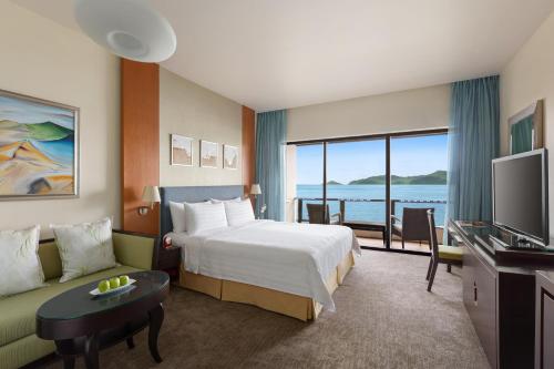a hotel room with a bed and a television at Shangri-La Tanjung Aru, Kota Kinabalu in Kota Kinabalu