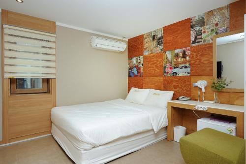 Postel nebo postele na pokoji v ubytování Hotel MIDO Myeongdong