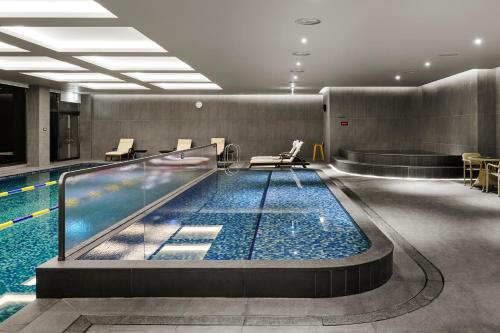 a large swimming pool in a building at Hotel Hyundai by Lahan Ulsan in Ulsan