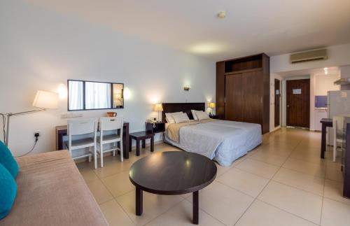 a hotel room with a bed and a table at MarisMare Apartments in Ayia Napa