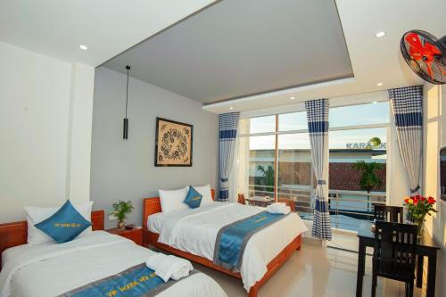 Postel nebo postele na pokoji v ubytování Vip House Hoi An Homestay