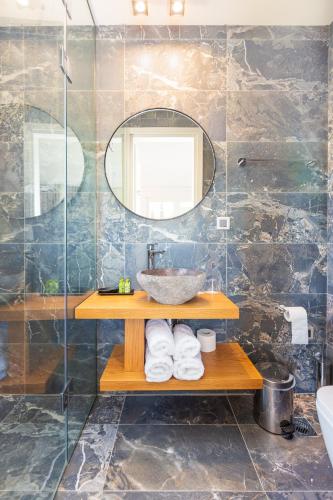 a bathroom with a sink and a mirror at 180 South Seaside Hotel in Thermisia