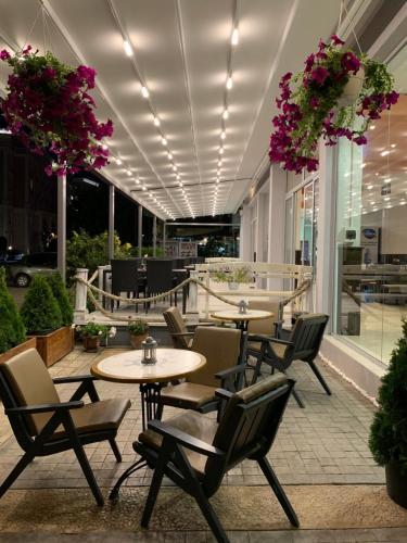 a restaurant with tables and chairs and flowers at Persani Hotel-Free Parking in Sunny Beach