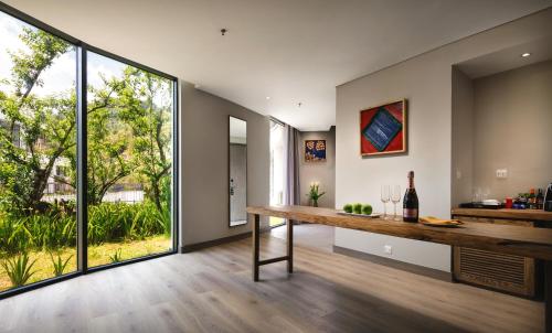 a dining room with a table and a large window at Pao's Sapa Leisure Hotel in Sa Pa