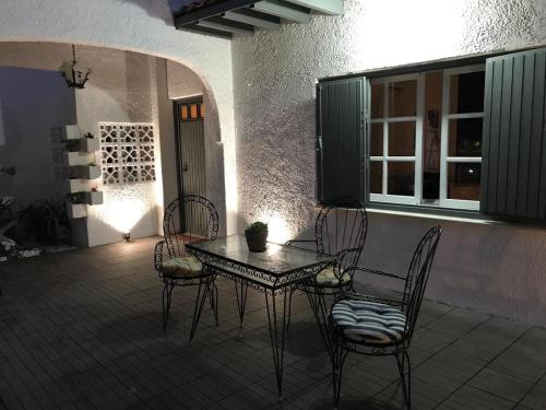 a table and chairs sitting on a patio at Athens Airport, Seaside house in Artemida