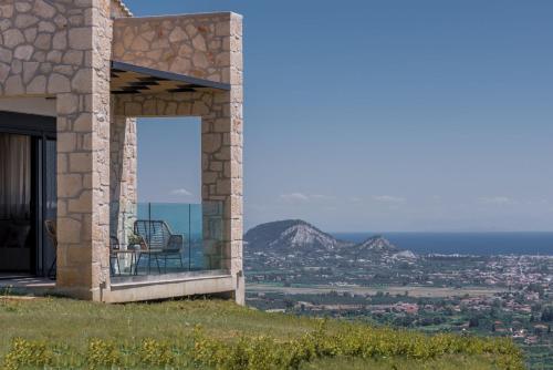 a house on a hill with a view of the ocean at Zinos Luxury Villa in Lithakia