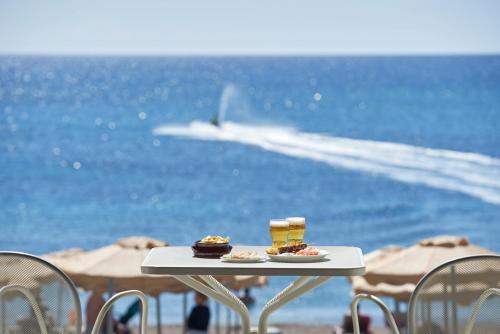 a table with food on it on the beach at Rodos Princess Beach Hotel in Kiotari