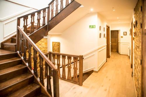 a staircase in a house with wooden floors at Hotel portico in Fonsagrada