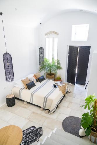 a bedroom with a large bed and a table at Euphoria Chora Naxos in Naxos Chora