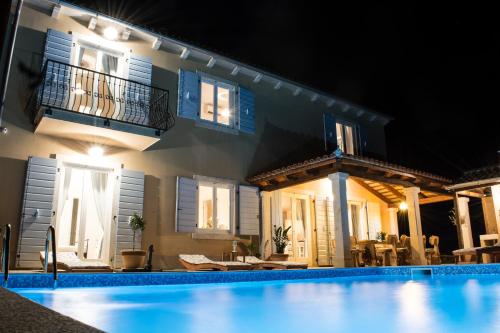 a villa with a swimming pool at night at Villa Histria Relax in Svetvinčenat