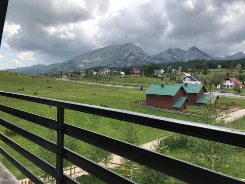 a view of the mountains from the balcony of a house at Guest house Sky Blue in Žabljak