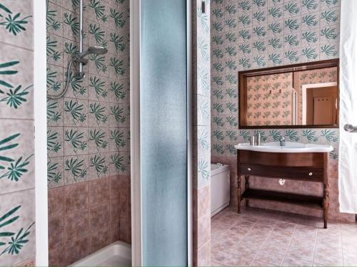 due immagini di un bagno con lavandino e specchio di Milano Moscova Apartment a Milano