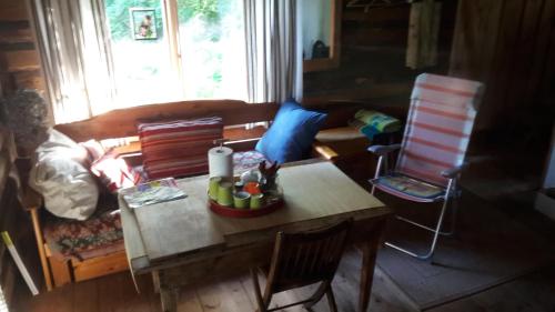 a living room with a table and a couch at Kenni Holiday House in Kenni