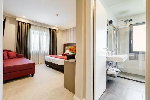 a hotel room with a bed and a bathroom at Eurogarden Hotel in Rome