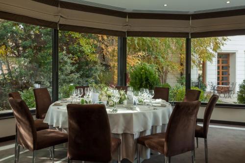 a dining room with a table and chairs at Epoque Hotel - Relais & Chateaux in Bucharest