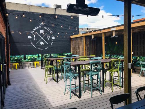 a restaurant with tables and chairs on a deck at The Market House in Reading
