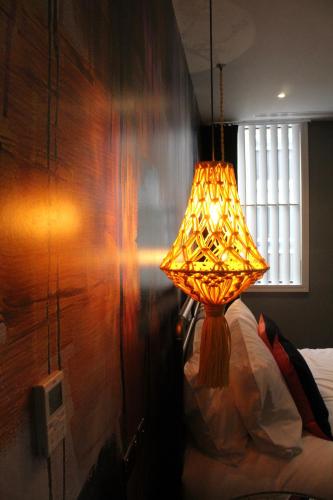 a lamp sitting next to a bed in a room at The Market House in Reading