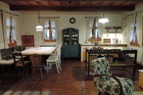 a kitchen and dining room with a table and chairs at Drevenica Inga in Staré Hory