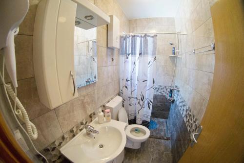 a small bathroom with a sink and a toilet at Apartment Maša in Trebinje