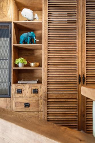 a wooden cabinet with a stuffed elephant on it at Reverence Boutique Hotel in Varna City