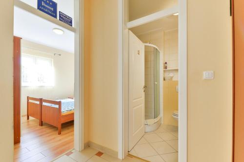 a bathroom with a toilet and a sink in a room at Apartments Đaković in Pakoštane