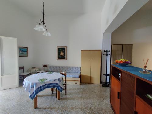 a living room with a table and a kitchen at Miramare palazzo Tamborino in Santa Cesarea Terme