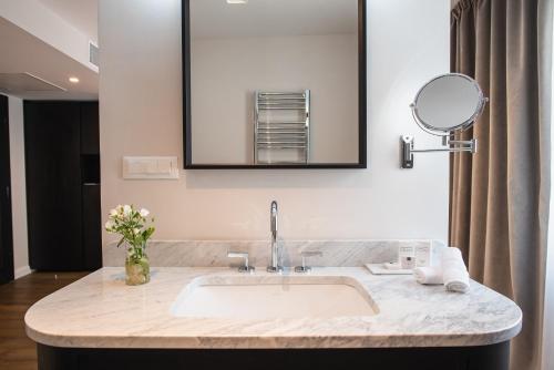 a bathroom with a sink and a mirror at Hotel Florian&Godler in Karlovac