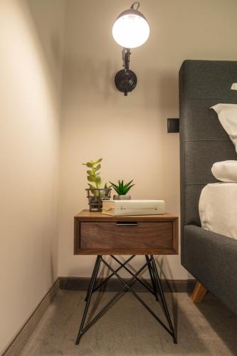 a table with plants on it next to a bed at Reverence Boutique Hotel in Varna City
