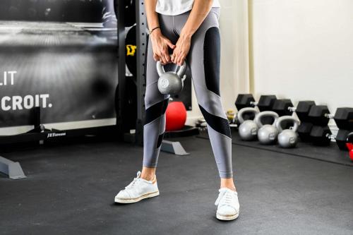 a woman in a gym holding a barbell at Logis Thermal in Saubusse