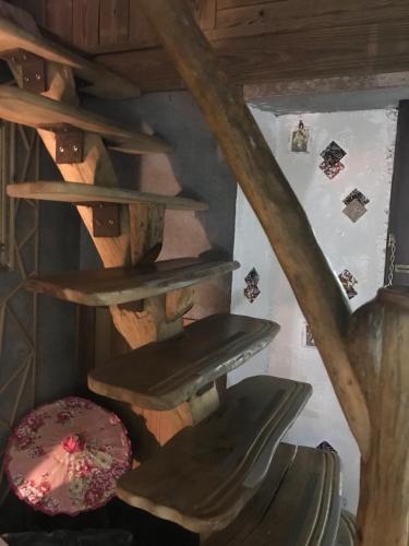 a wooden spiral staircase in a room with a wall at A-HOME in Jiufen
