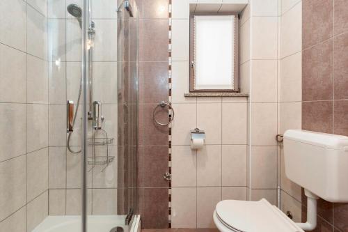 a bathroom with a shower and a toilet at Meri in Premantura