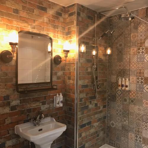 a bathroom with a sink and a shower at The Market House in Reading