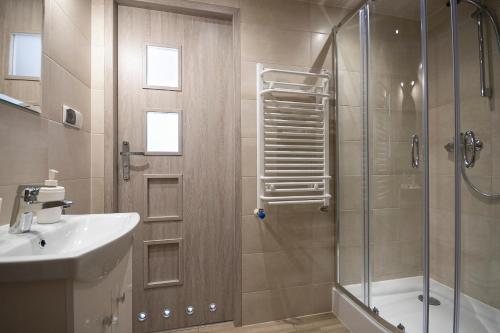 een badkamer met een douche en een wastafel bij Apartament "Rodzinny zakątek" in Duszniki Zdrój