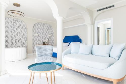 a living room with a white couch and a table at Hotel Club Due Torri in Maiori
