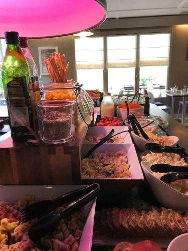a buffet filled with lots of different types of food at Campanile NATURE - Cahors in Cahors