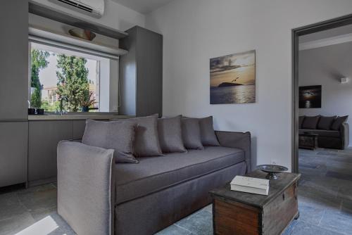 a living room with a couch and a table at Nikolaou Art Residence in Aegina Town