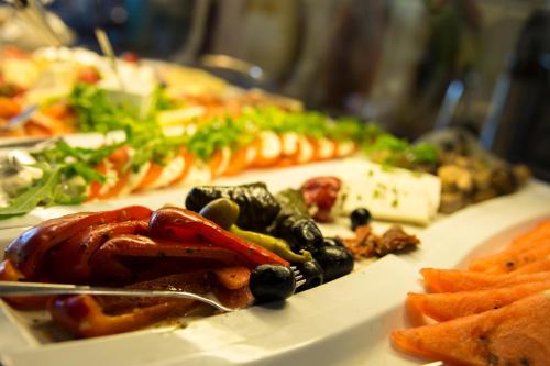 a plate of food with vegetables on a table at Villa-Meehr in Bantikow