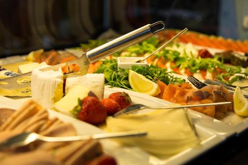 a buffet of food with plates of food on a table at Villa-Meehr in Bantikow