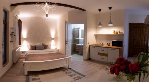 a bedroom with a large bed and a bathroom at Samuel Wagner in Sibiu