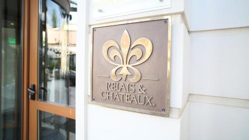 a sign on the side of a door to a restaurant at Epoque Hotel - Relais & Chateaux in Bucharest